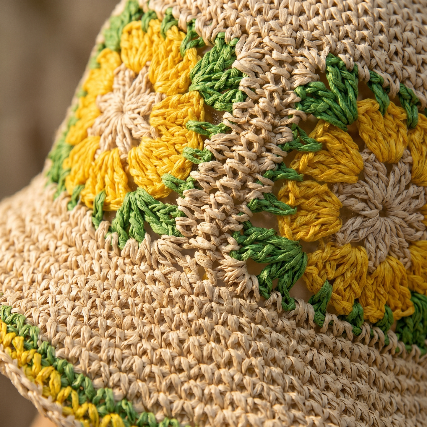 Close-up of the hand-crocheted flowers and woven paper straw