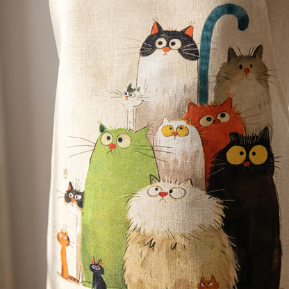 Close-up of the linen weave and the ten cats stitched onto the apron