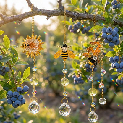 Three crystal light-catchers hanging in a sunlit blueberry garden scattering rainbow light