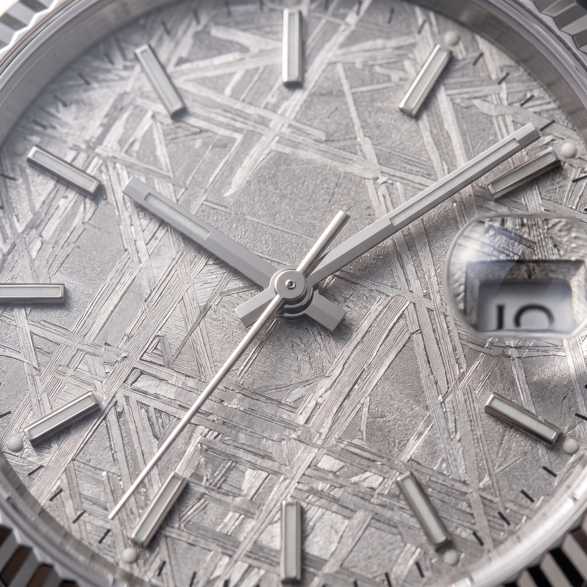 Macro of the meteorite dial showing the fine Widmanstatten crosshatch