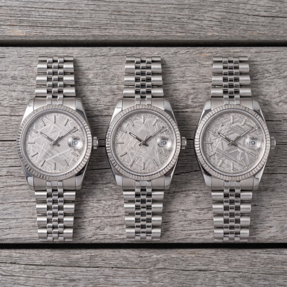 Three watches side by side, each dial a different natural meteorite pattern