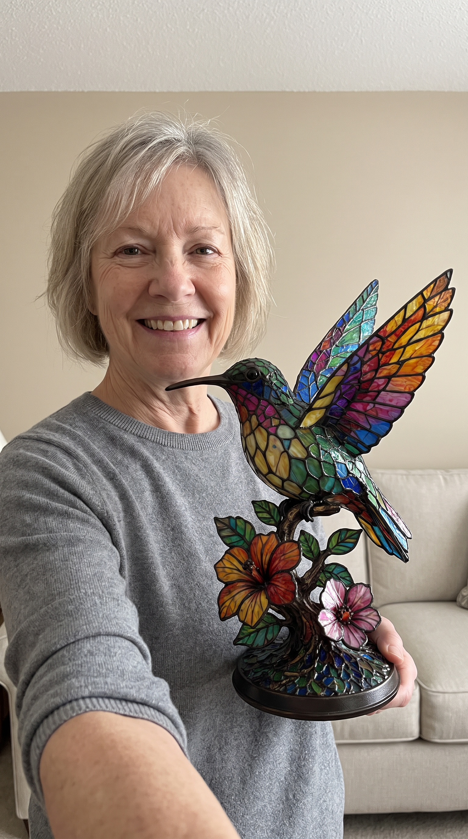 Customer selfie holding the hummingbird lamp