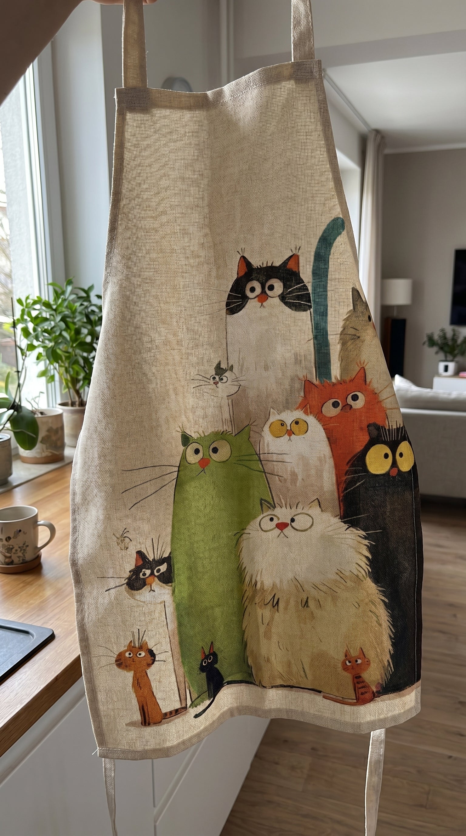 Customer photo of the cat apron in a bright home kitchen